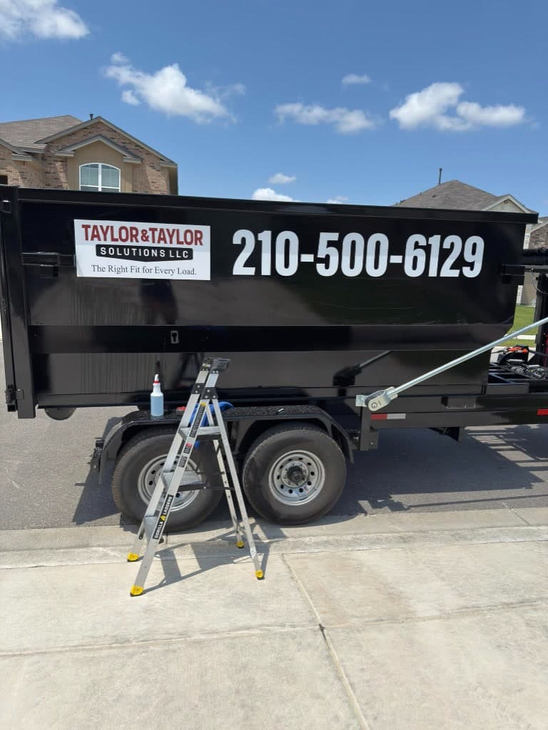 Fresh Taylor & Taylor branding decal on a black dumpster trailer